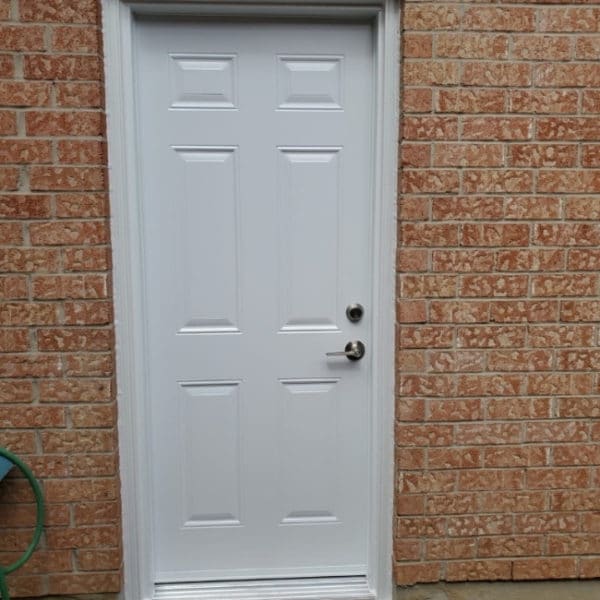Image depicts a new white entry door from our installation project in Maple.