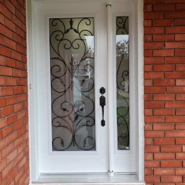 Image depicts a home with a new white entry door from VR Windows & Doors.